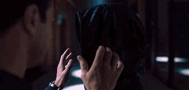 a man is putting a scarf on a woman 's face