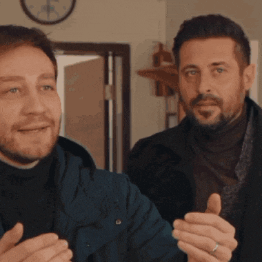a man with a ring on his finger is standing next to another man