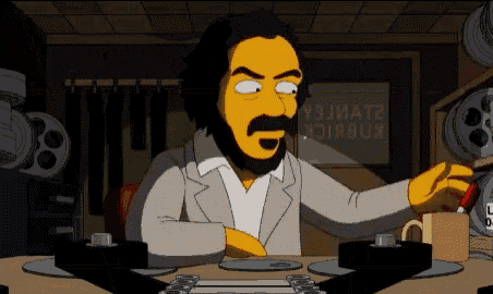 a cartoon of a man with a beard and mustache sitting at a desk