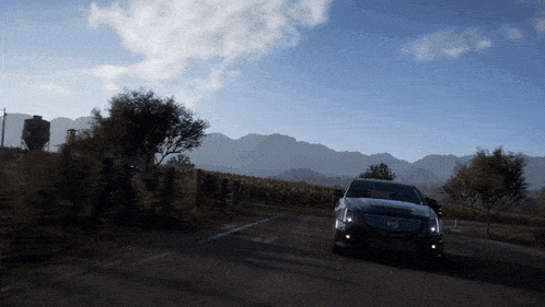 a cadillac is driving down a country road