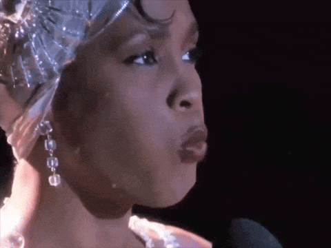 a close up of a woman 's face with a microphone in front of her