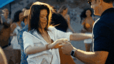 a man and a woman are dancing together in a crowd