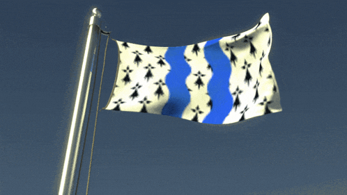 a blue and white flag is waving in the wind against a blue sky