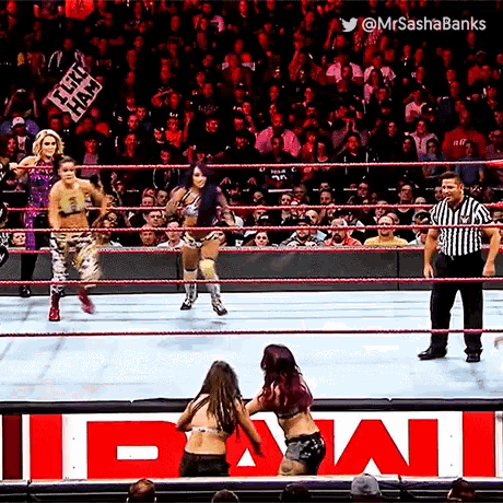 two women are wrestling in a ring with a referee and a sign that says ipwi on it