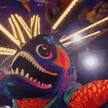 a colorful fish with sharp teeth and a red eye