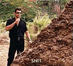 a man is standing next to a pile of dirt and talking to himself .