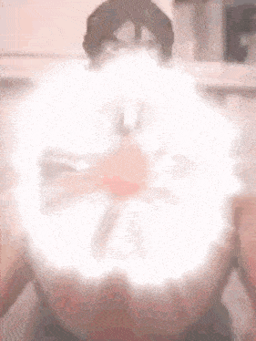 a blurry picture of a person with a light coming out of their chest .