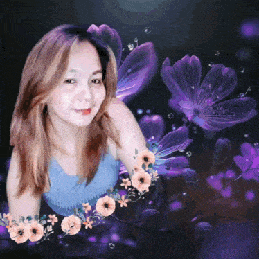 a woman in a blue top is surrounded by purple and pink flowers