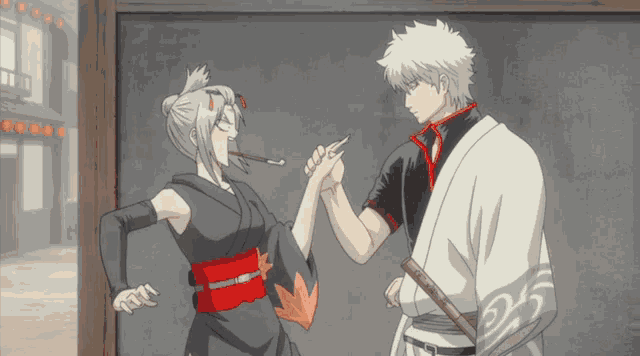 a man and a woman are standing next to each other and the man is wearing a kimono
