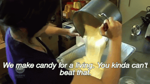 a woman is pouring candy into a pan with the words " we make candy for a living you kinda can beat that " below her