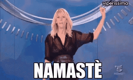 a woman is standing in front of a sign that says namaste on it