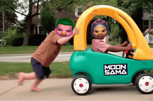 a green and yellow toy car with moon sama written on the side
