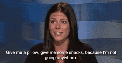 a woman is giving a pillow and some snacks because she is not going anywhere
