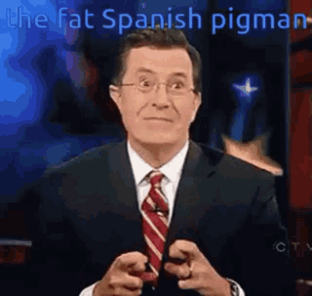a man in a suit and tie is pointing at the camera with the words `` the fat spanish pigman '' above him .