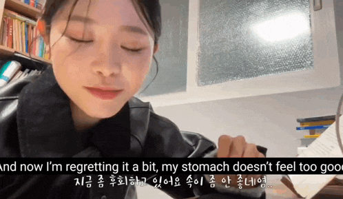 a woman is sitting at a desk with her eyes closed and the words and now i 'm regretting
