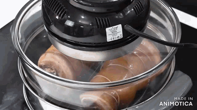 a food cooking in a glass container with the words made in animatica on the bottom