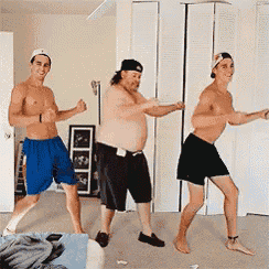 three men are dancing in a room and one of them is a shirtless man