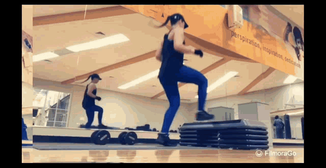 a woman is doing exercises in a gym with a sign that says perspiration