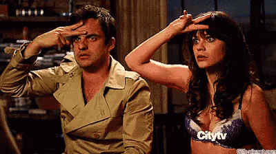 a man and a woman are sitting next to each other and the woman is wearing a bra that says citytv on it .