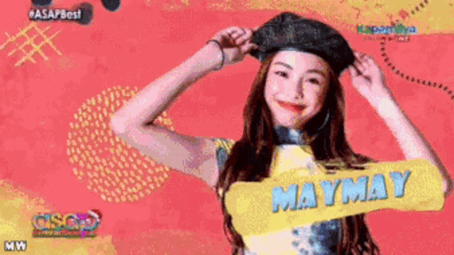 a woman is wearing a hat and has the name maymay on her shirt