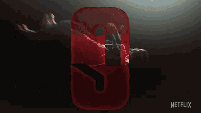 a red netflix logo with a person laying on it