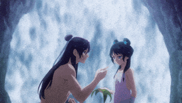 a man and a little girl are standing next to each other in front of a waterfall