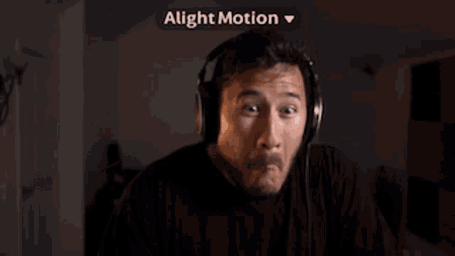 a man wearing headphones is making a funny face and the word alight motion is above him