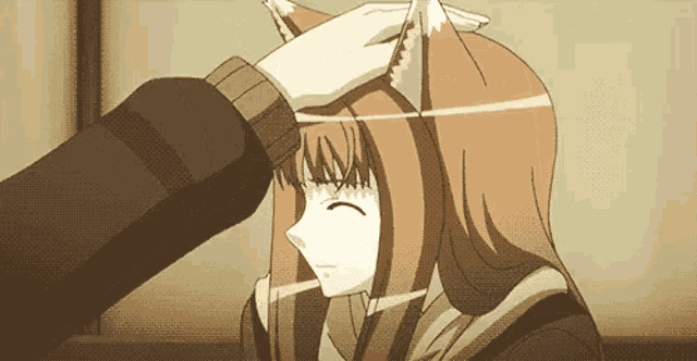a person is touching the head of a girl with fox ears .