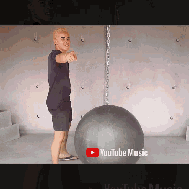 a youtube music ad with a man pointing at the camera