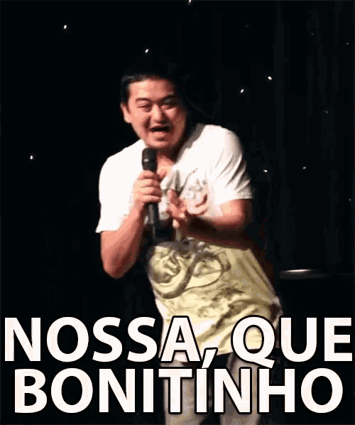 a man is holding a microphone and says nossa que bonitinho