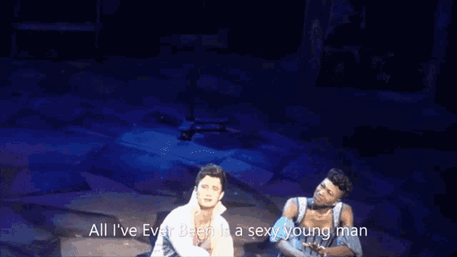 a man and a woman on a stage with the words with a tight body and a lot of feelings