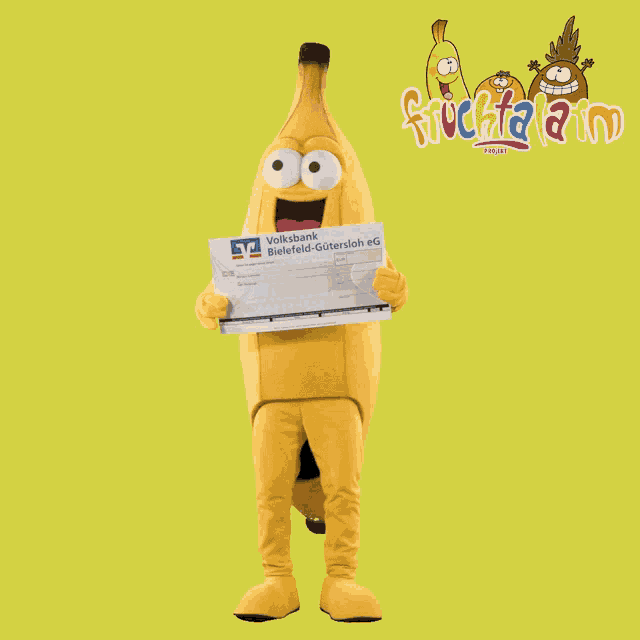 a banana mascot holds a check from volksbank
