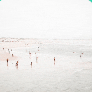 a group of people are playing in the water at the beach