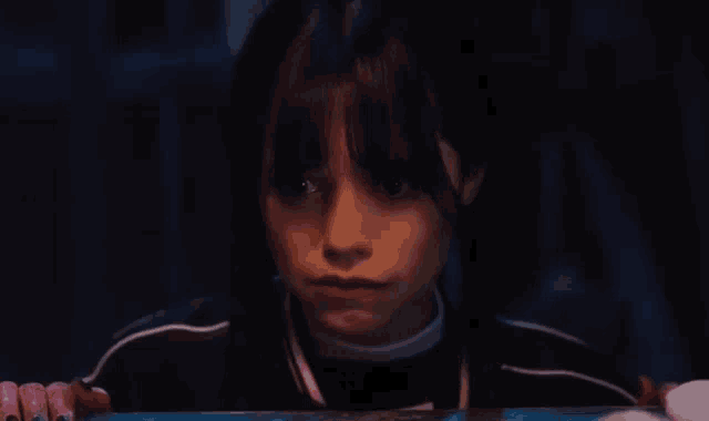 a close up of a girl 's face with a serious look on her face