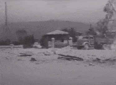 a black and white photo of a military vehicle with a license plate that says snw
