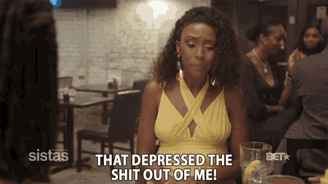 a woman in a yellow dress says " that depressed the shit out of me " while sitting at a table