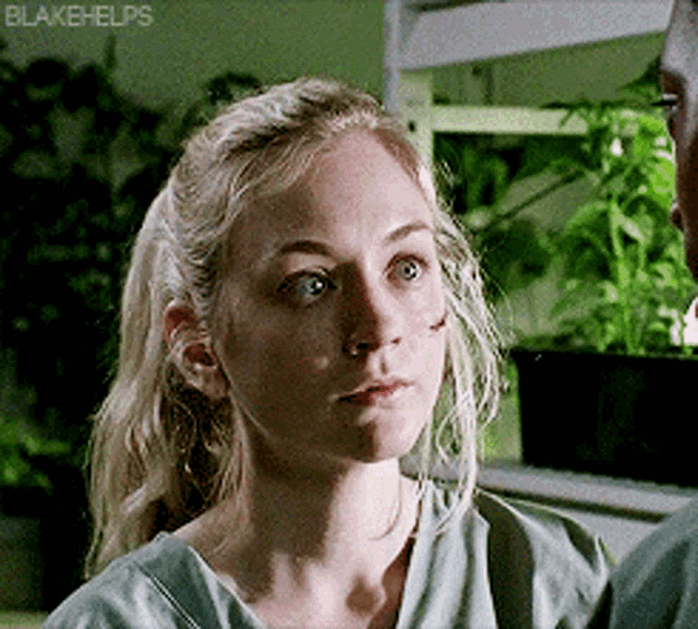 a woman in a green shirt with blakehelps on the bottom right