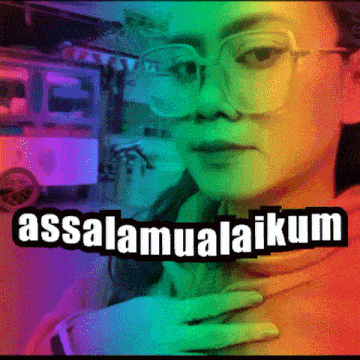 a woman wearing glasses is surrounded by a rainbow colored background that says assalamualaikum
