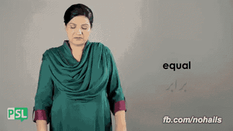 a woman in a green dress stands in front of a sign that says " equal "