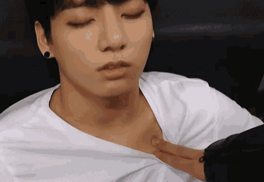 a close up of a person touching a person 's chest .
