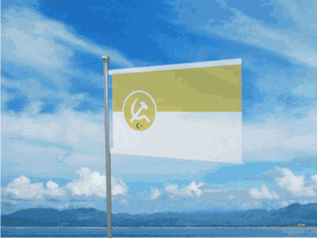 a flag with a hammer and sickle on it is flying in the wind