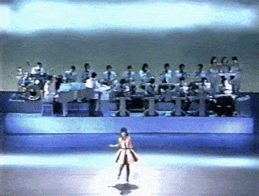 a group of people are playing instruments on a stage