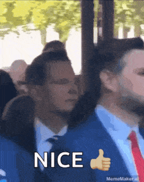 a man in a suit and tie giving a thumbs up with the word nice