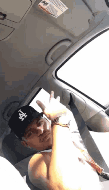 a man wearing a hat with the letter a on it