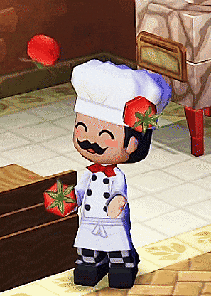 a chef with a mustache is holding a tomato and smiling