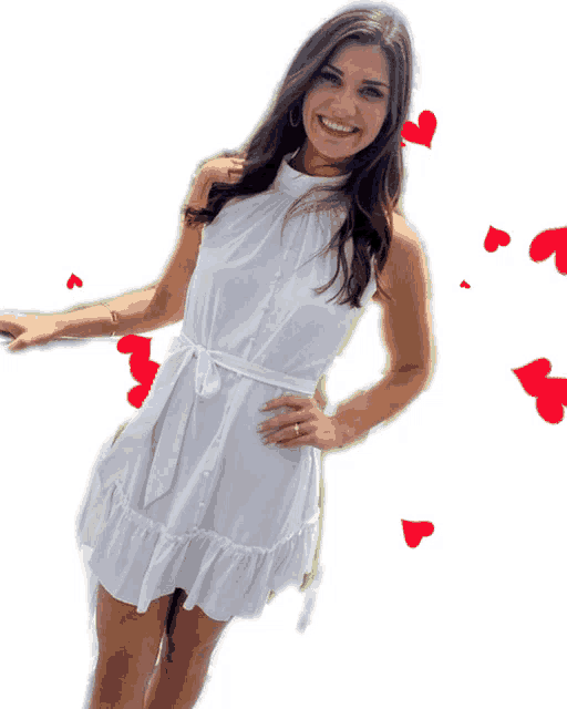 a woman in a white dress is smiling with red hearts in the background