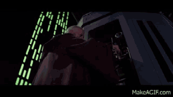 a man in a robe is standing in front of a building with a glowing sign that says makeagif.com