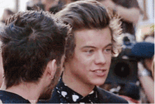 two men are standing next to each other and one of them is wearing a bow tie .
