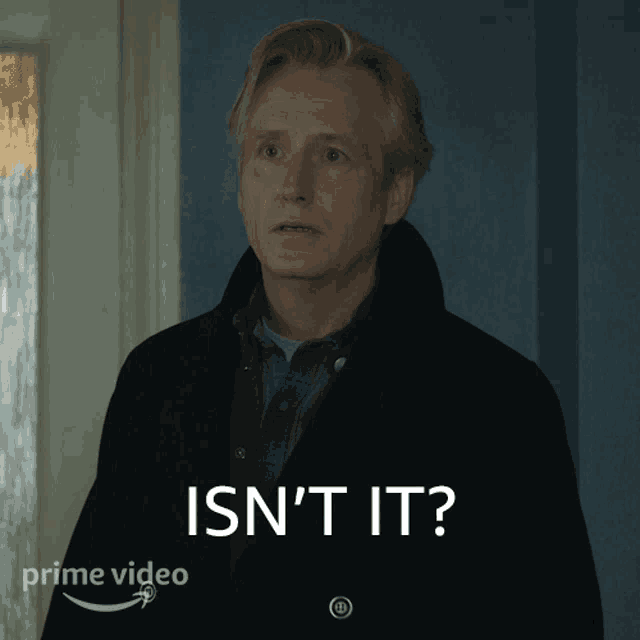 a man is standing in front of a sign that says isn 't it on it