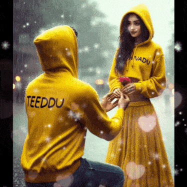a man in a yellow hoodie with the word teeddu on the back proposes to a woman in a yellow dress